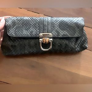 Barley used Gucci python clutch
